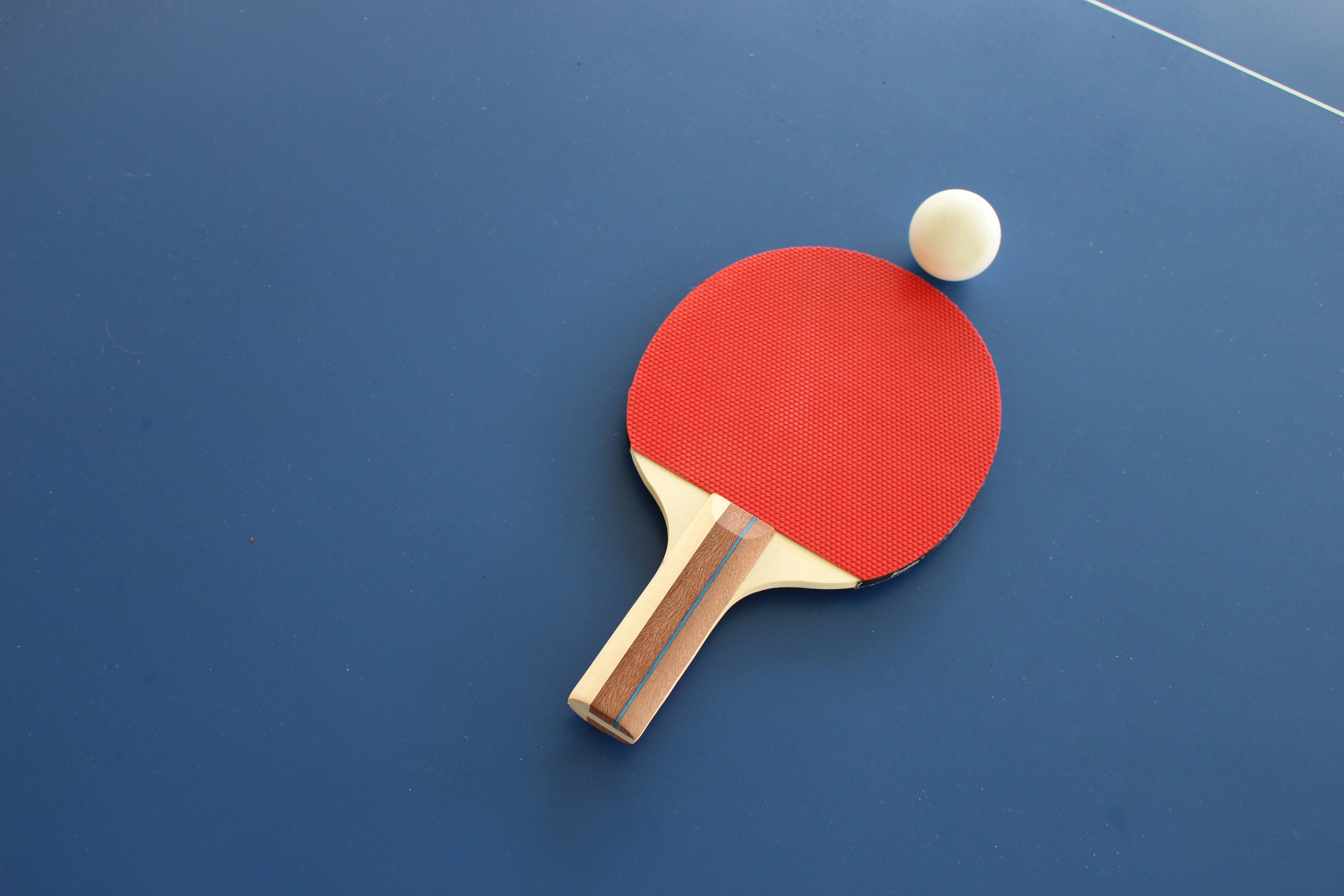 Table tennis paddle and ball.